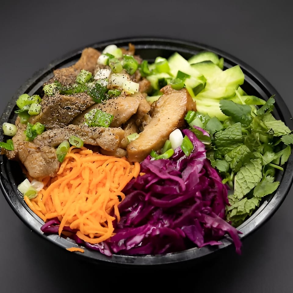 PhoGo Express's Vietnamese bowl with grilled meat, shredded carrots, red cabbage, and fresh herbs.