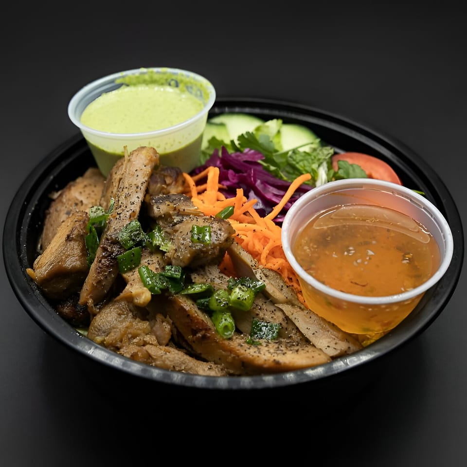 PhoGo Express Vietnamese grilled pork with green onions, shredded carrots, red cabbage, and two dipping sauces.